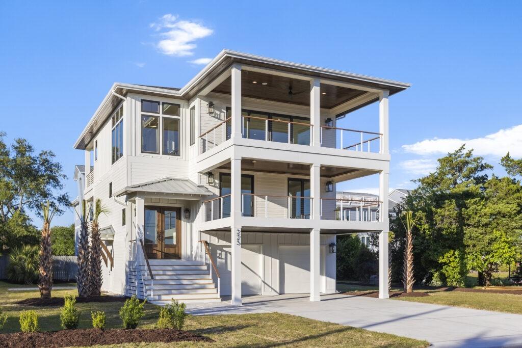 Elevated coastal designs with stilts protect homes from flooding and storm surges, ensuring safety and resilience