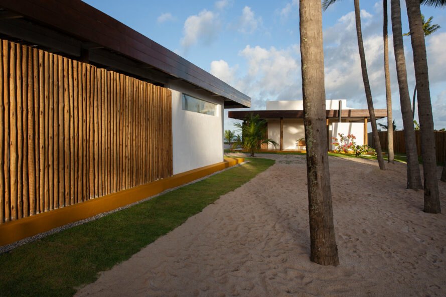Coastal beach house exterior featuring weathered wood, stone, and shingles, blending with the landscape and enduring coastal weather