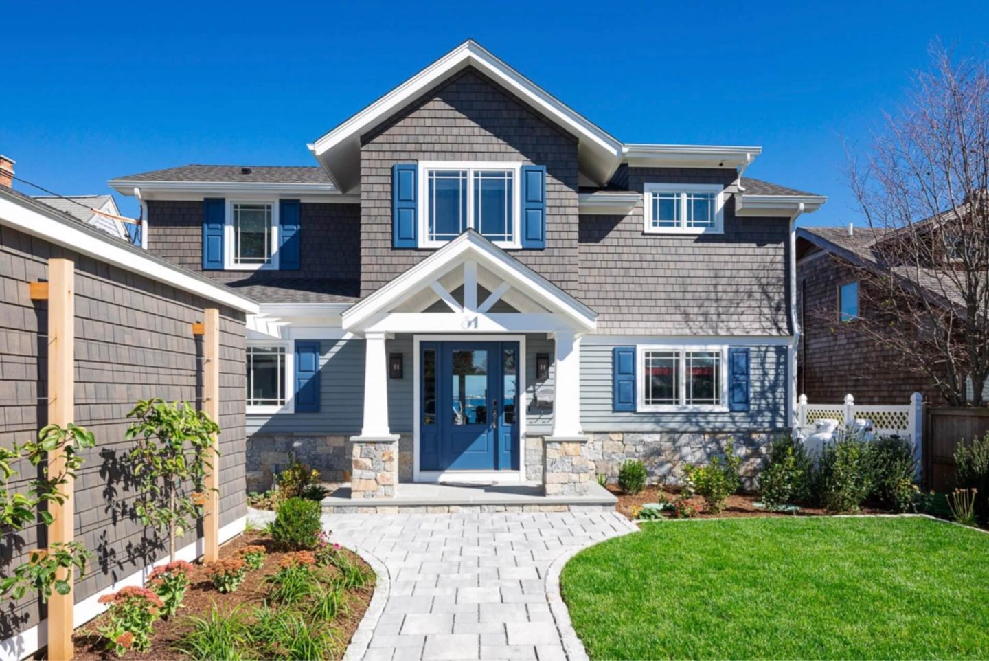 Coastal beach house exterior featuring soft whites, blues, seafoam greens, and sandy neutrals, reflecting shore hues.
