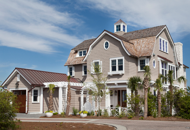 Exterior of a modern coastal beach house showcasing durable cedar or composite shingles in a classic, weathered style