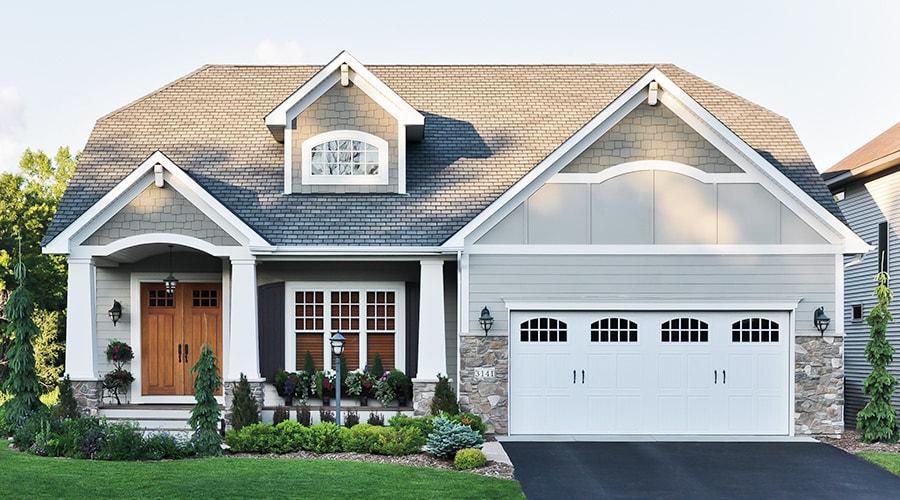 Stylish coastal beach house with a gabled roof and dormer windows, blending modern design with a relaxed beach vibe