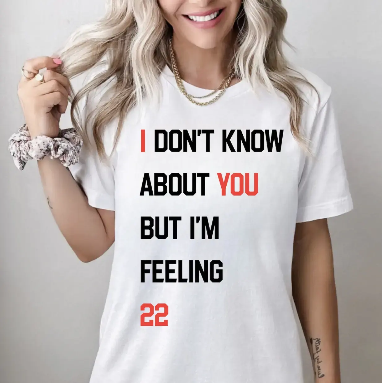 A women wearing graphic tee the text I don't know about you but I'm feeling 22 written on the tee