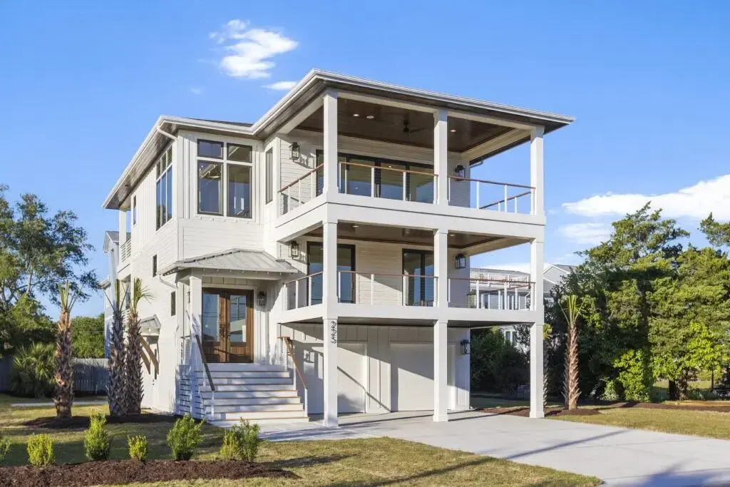Elevated coastal designs with stilts protect homes from flooding and storm surges, ensuring safety and resilience