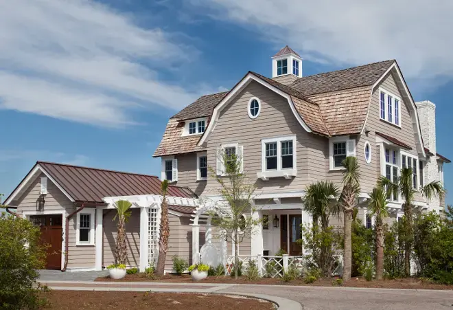 Exterior of a modern coastal beach house showcasing durable cedar or composite shingles in a classic, weathered style