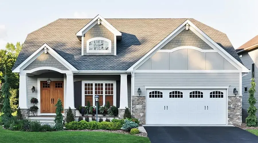Stylish coastal beach house with a gabled roof and dormer windows, blending modern design with a relaxed beach vibe
