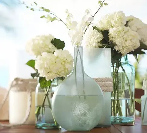 table decor featuring elegant vases made of beach glass