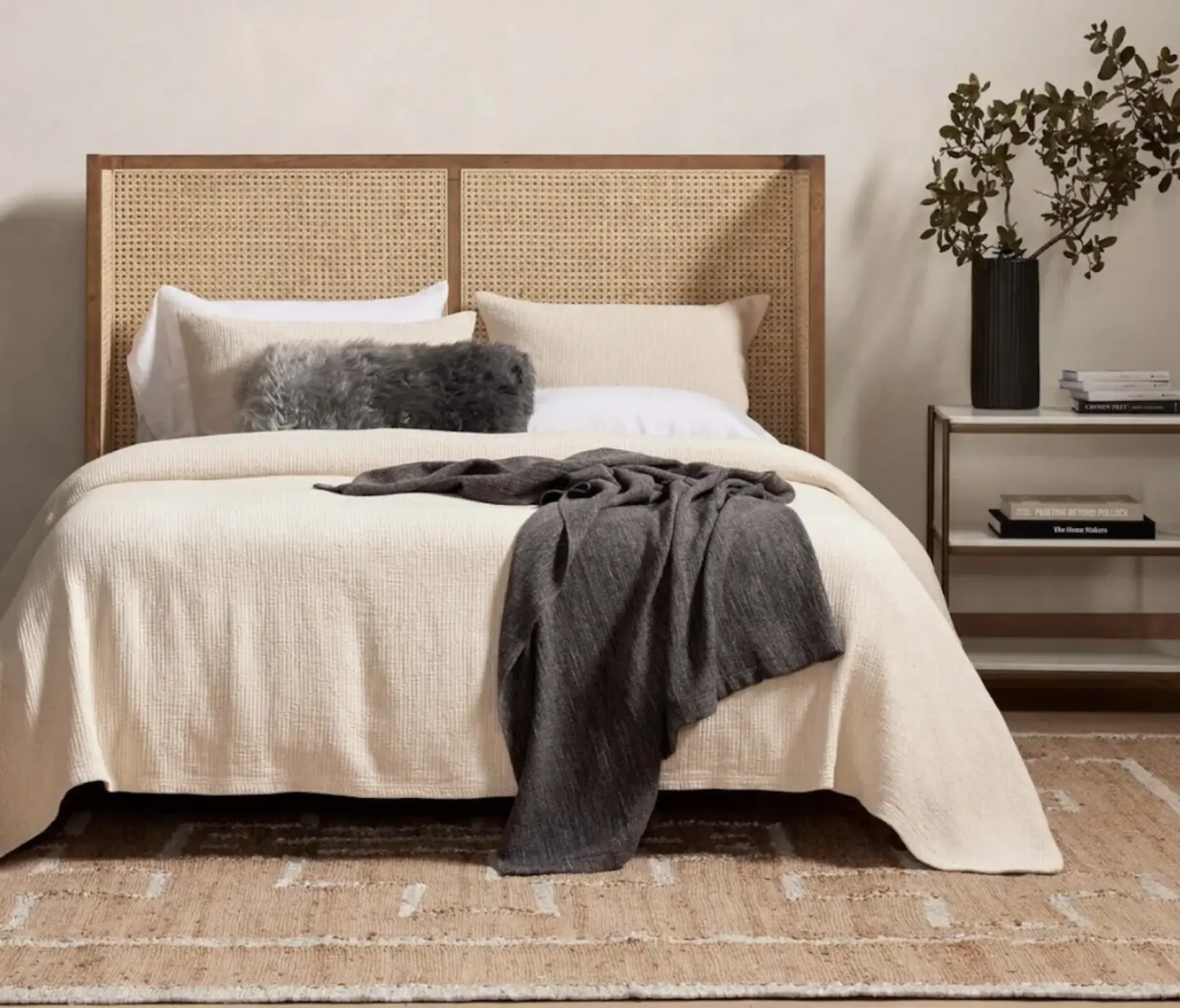  Soft bedding paired with rattan elements creates a warm